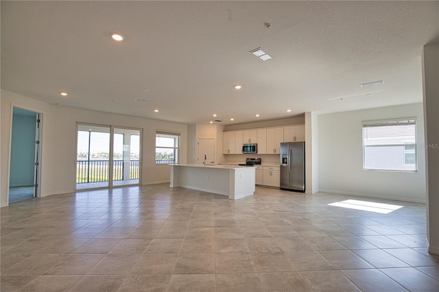 17715 Boracay Ct Unit 202, Venice, FL 34293 - kitchen with stainless steel appliances, open floor plan, light countertops, recessed lighting, and baseboards