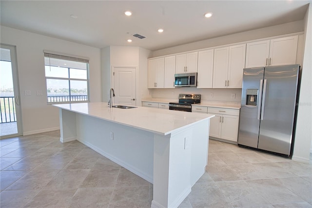 17715 Boracay Ct Unit 202, Venice, FL 34293 - kitchen with appliances with stainless steel finishes, a sink, an island with sink, white cabinetry, and recessed lighting