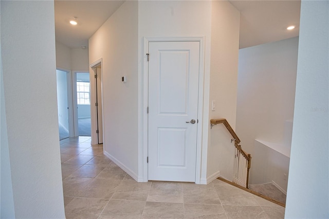 17715 Boracay Ct Unit 202, Venice, FL 34293 - hallway with an upstairs landing, light tile patterned flooring, recessed lighting, and baseboards