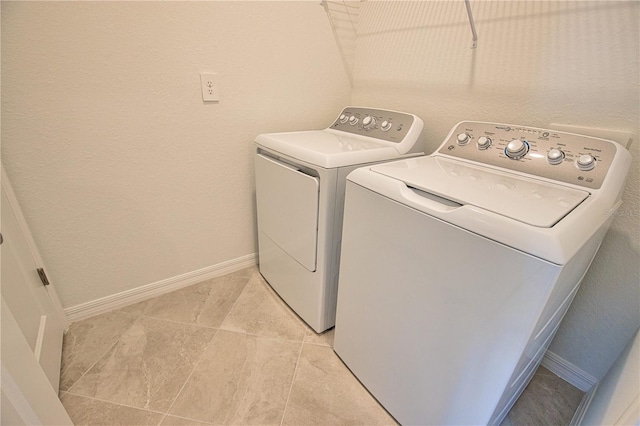 17715 Boracay Ct Unit 202, Venice, FL 34293 - laundry room with washer and clothes dryer, baseboards, and light tile patterned floors