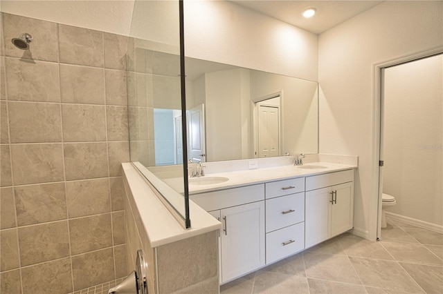 17715 Boracay Ct Unit 202, Venice, FL 34293 - full bath with double vanity, tile patterned floors, toilet, a tile shower, and baseboards