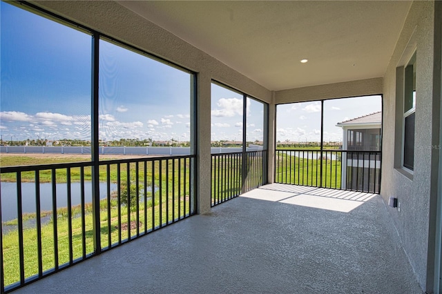 17715 Boracay Ct Unit 202, Venice, FL 34293 - unfurnished sunroom featuring a water view, a textured wall, and recessed lighting