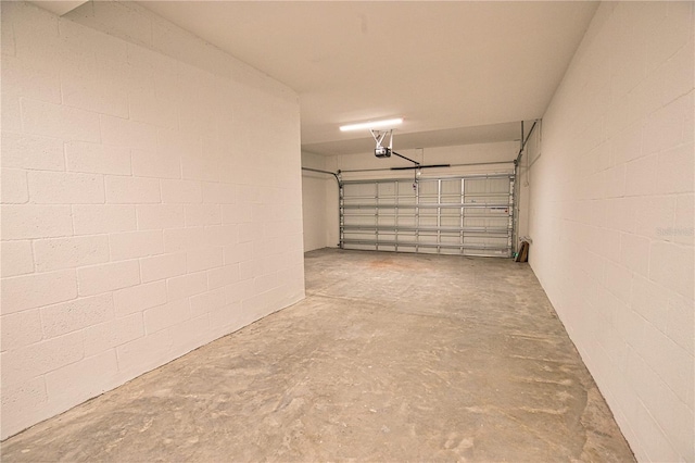 17715 Boracay Ct Unit 202, Venice, FL 34293 - garage featuring a garage door opener and concrete block wall