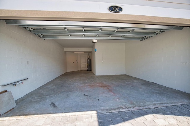 17715 Boracay Ct Unit 202, Venice, FL 34293 - garage featuring water heater, a garage door opener, and concrete block wall
