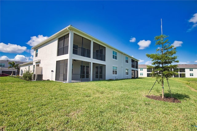 17715 Boracay Ct Unit 202, Venice, FL 34293 - back of property with a lawn, stucco siding, and central AC