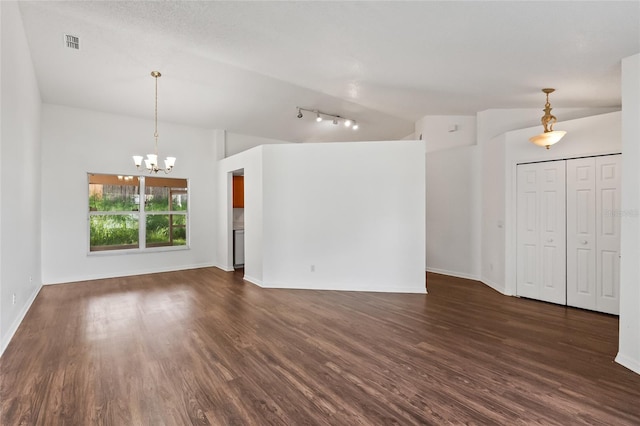 294 Lake Doe Blvd, Apopka, FL 32703 - unfurnished living room featuring vaulted ceiling, a chandelier, dark wood finished floors, and rail lighting
