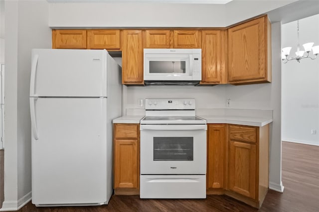 294 Lake Doe Blvd, Apopka, FL 32703 - kitchen with white appliances, dark wood-style floors, a chandelier, and light countertops