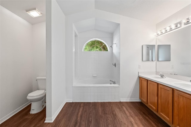 294 Lake Doe Blvd, Apopka, FL 32703 - bathroom featuring wood finished floors, double vanity, lofted ceiling, and tiled shower / bath