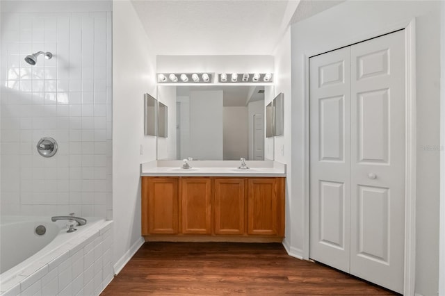 294 Lake Doe Blvd, Apopka, FL 32703 - full bath with a closet, double vanity, wood finished floors, and tiled shower / bath combo