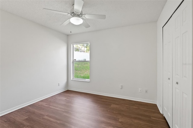 294 Lake Doe Blvd, Apopka, FL 32703 - unfurnished bedroom featuring a closet, dark wood finished floors, a textured ceiling, and a ceiling fan