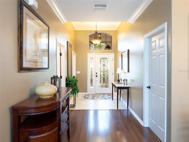 8078 Stirling Falls Cir, Sarasota, FL 34243 - foyer with ornamental molding, dark wood-style floors, a chandelier, and baseboards