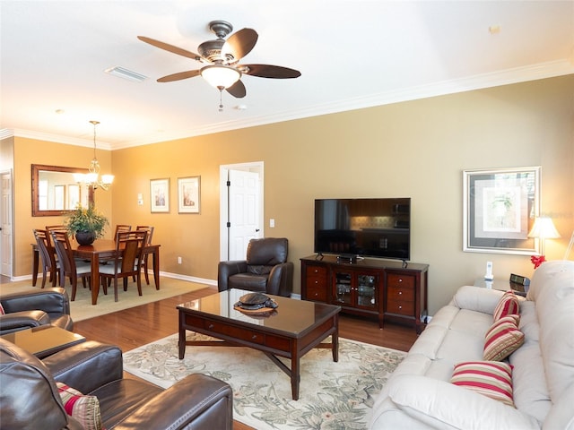 8078 Stirling Falls Cir, Sarasota, FL 34243 - living room with ornamental molding, wood finished floors, a chandelier, a ceiling fan, and baseboards