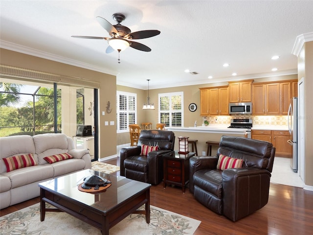 8078 Stirling Falls Cir, Sarasota, FL 34243 - living area with wood finished floors, a ceiling fan, crown molding, recessed lighting, and baseboards