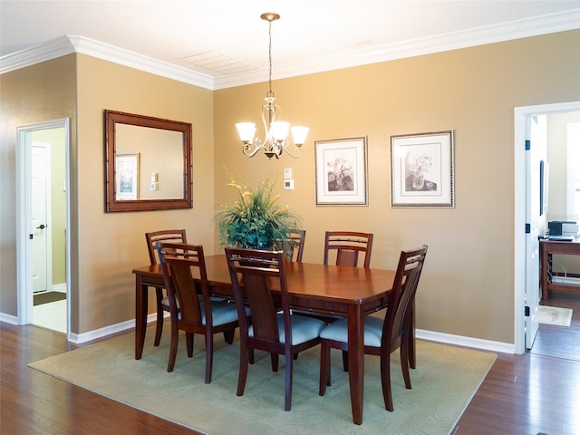 8078 Stirling Falls Cir, Sarasota, FL 34243 - dining room with dark wood-style floors, a chandelier, crown molding, and baseboards