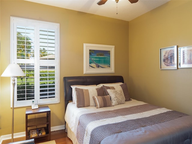 8078 Stirling Falls Cir, Sarasota, FL 34243 - bedroom featuring multiple windows, wood finished floors, baseboards, and a ceiling fan