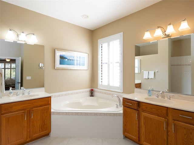8078 Stirling Falls Cir, Sarasota, FL 34243 - ensuite bathroom featuring two vanities, a garden tub, and tile patterned flooring
