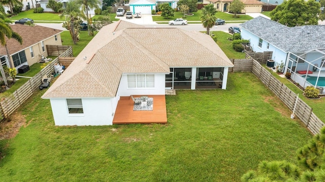 9402 71st Ave E, Palmetto, FL 34221 - back of property with stucco siding, a sunroom, a residential view, and roof with shingles