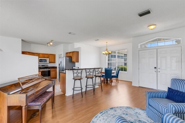 9402 71st Ave E, Palmetto, FL 34221 - living area with a chandelier and light wood-type flooring
