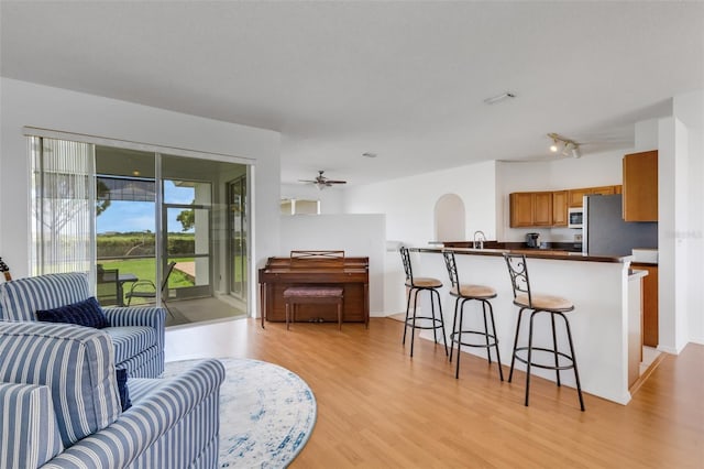 9402 71st Ave E, Palmetto, FL 34221 - living area featuring light wood finished floors, ceiling fan, and baseboards