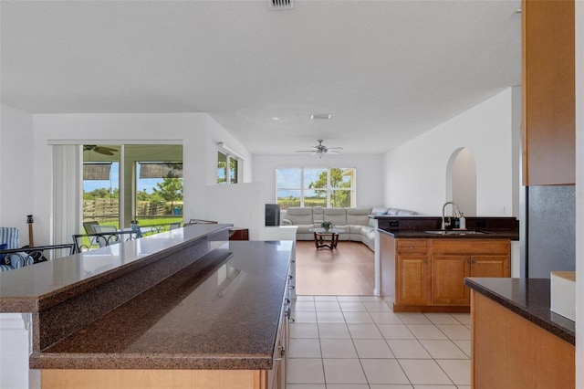 9402 71st Ave E, Palmetto, FL 34221 - kitchen featuring a sink, a ceiling fan, light tile patterned floors, open floor plan, and a center island
