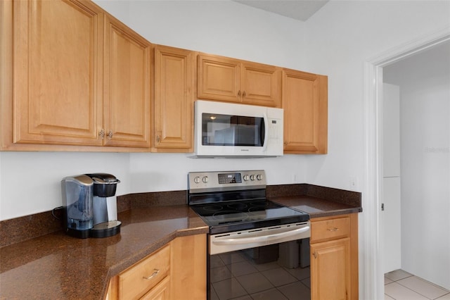 9402 71st Ave E, Palmetto, FL 34221 - kitchen with electric range, white microwave, and light tile patterned floors