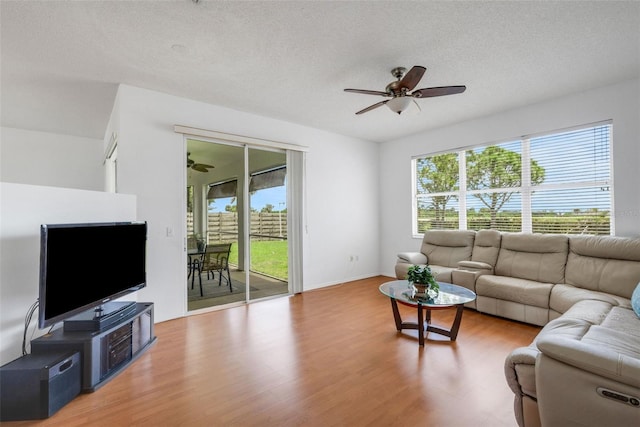 9402 71st Ave E, Palmetto, FL 34221 - living area featuring ceiling fan, wood finished floors, healthy amount of natural light, and a textured ceiling