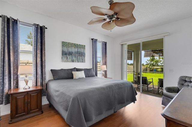 9402 71st Ave E, Palmetto, FL 34221 - bedroom featuring access to exterior, wood finished floors, and ceiling fan