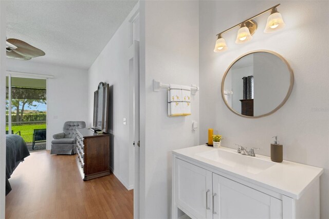 9402 71st Ave E, Palmetto, FL 34221 - bathroom with wood finished floors, vanity, a ceiling fan, and baseboards