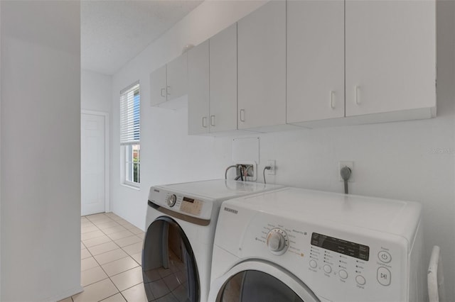 9402 71st Ave E, Palmetto, FL 34221 - washroom featuring washing machine and clothes dryer, cabinet space, and light tile patterned floors