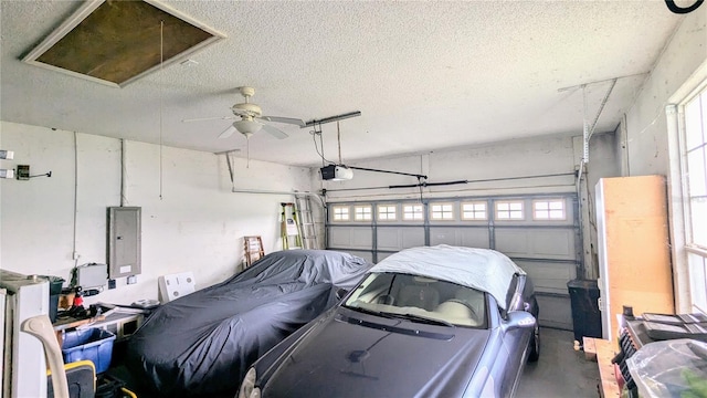 9402 71st Ave E, Palmetto, FL 34221 - garage with electric panel, a garage door opener, and a ceiling fan