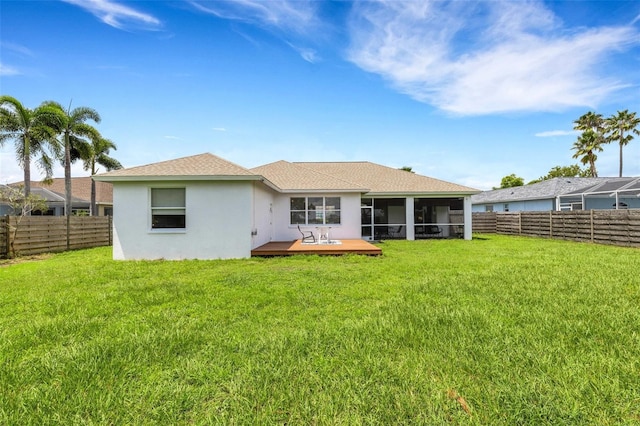 9402 71st Ave E, Palmetto, FL 34221 - rear view of house featuring a sunroom, a wooden deck, stucco siding, and roof with shingles