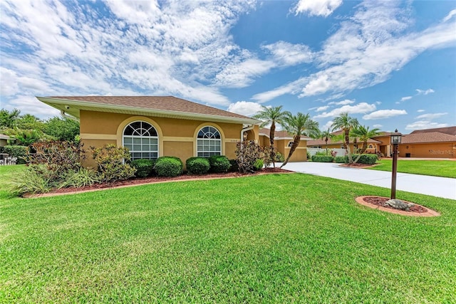 5359 90th Avenue Cir E, Parrish, FL 34219 - mediterranean / spanish home featuring stucco siding, a front yard, and driveway