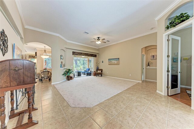 5359 90th Avenue Cir E, Parrish, FL 34219 - living area with arched walkways, light tile patterned floors, a ceiling fan, crown molding, and baseboards