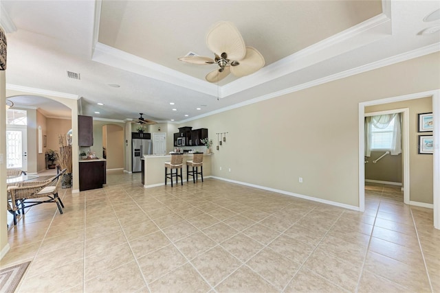 5359 90th Avenue Cir E, Parrish, FL 34219 - living area with arched walkways, light tile patterned floors, a raised ceiling, ceiling fan, and crown molding