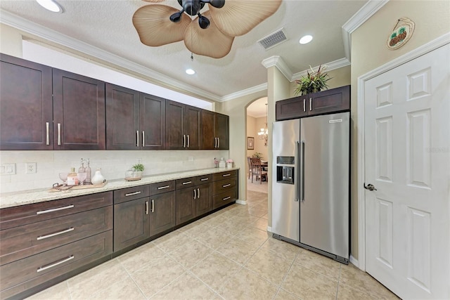 5359 90th Avenue Cir E, Parrish, FL 34219 - kitchen featuring high quality fridge, ornamental molding, arched walkways, a ceiling fan, and tasteful backsplash