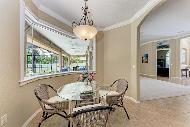 5359 90th Avenue Cir E, Parrish, FL 34219 - dining area with arched walkways, healthy amount of natural light, crown molding, ceiling fan, and light tile patterned floors