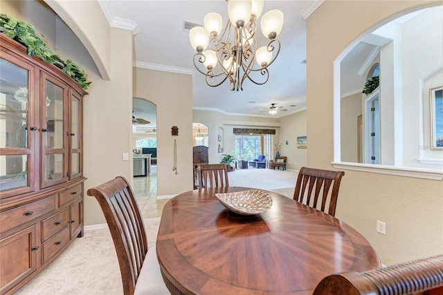 5359 90th Avenue Cir E, Parrish, FL 34219 - dining room with light carpet, ornamental molding, a chandelier, ceiling fan, and arched walkways