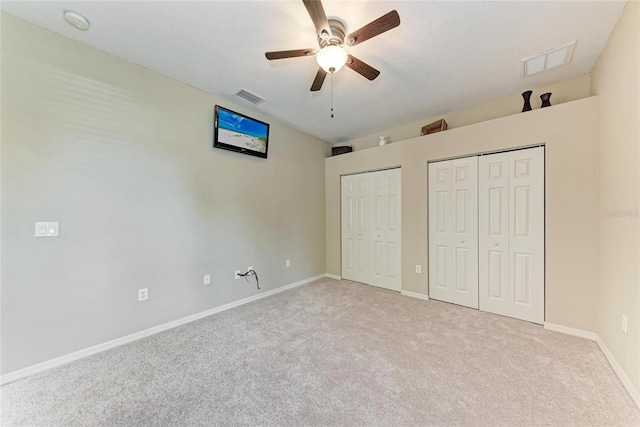 5359 90th Avenue Cir E, Parrish, FL 34219 - unfurnished bedroom with multiple closets, carpet floors, baseboards, and ceiling fan