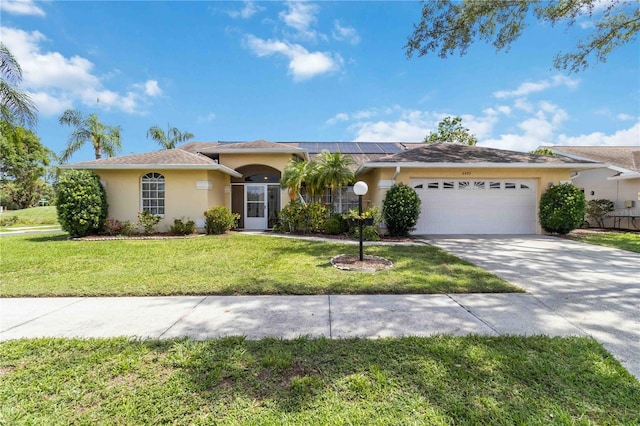 6405 Alesheba Ln, Sarasota, FL 34240 - ranch-style house with stucco siding, an attached garage, concrete driveway, solar panels, and a front yard