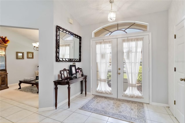 6405 Alesheba Ln, Sarasota, FL 34240 - tiled foyer with a chandelier, french doors, and baseboards