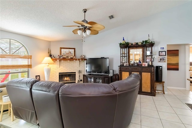 6405 Alesheba Ln, Sarasota, FL 34240 - living area with ceiling fan, a fireplace, light tile patterned floors, a textured ceiling, and vaulted ceiling