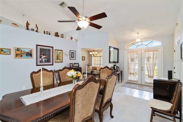 6405 Alesheba Ln, Sarasota, FL 34240 - dining space with french doors, a chandelier, vaulted ceiling, a ceiling fan, and light tile patterned flooring