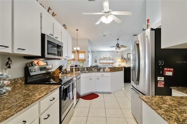 6405 Alesheba Ln, Sarasota, FL 34240 - kitchen with appliances with stainless steel finishes, ceiling fan, a peninsula, white cabinets, and stone counters