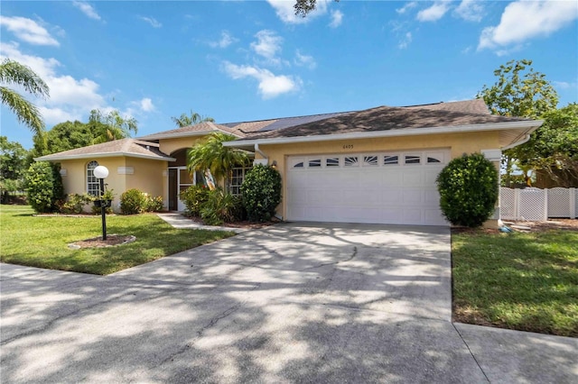 6405 Alesheba Ln, Sarasota, FL 34240 - view of front of home featuring stucco siding, an attached garage, a front lawn, and concrete driveway