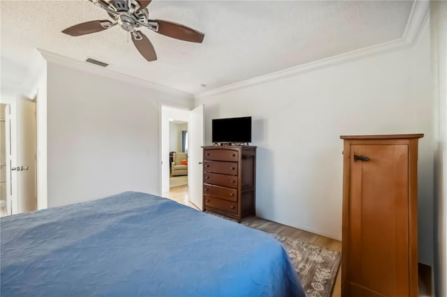 6860 Whitman Ct Unit 32B, Sarasota, FL 34243 - bedroom with crown molding, light wood-style floors, and a ceiling fan