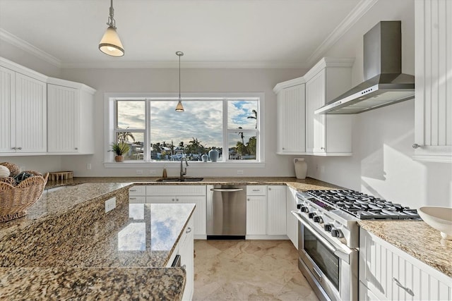 634 Key Royale Dr, Holmes Beach, FL 34217 - kitchen featuring wall chimney range hood, stainless steel appliances, a sink, white cabinets, and decorative light fixtures