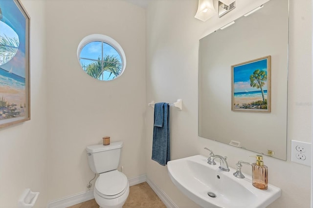 634 Key Royale Dr, Holmes Beach, FL 34217 - bathroom with a sink, toilet, and baseboards
