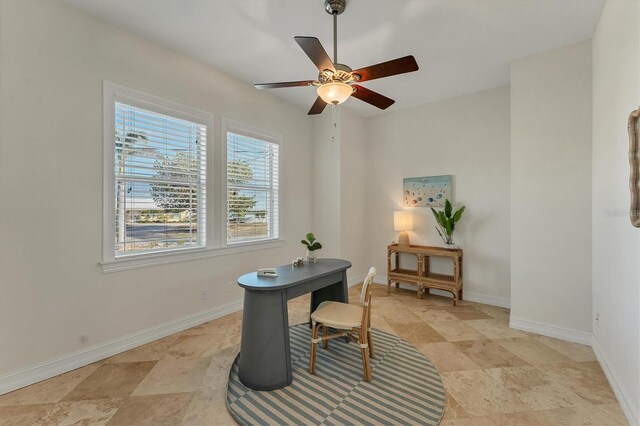 634 Key Royale Dr, Holmes Beach, FL 34217 - office featuring ceiling fan, baseboards, and light stone finish flooring