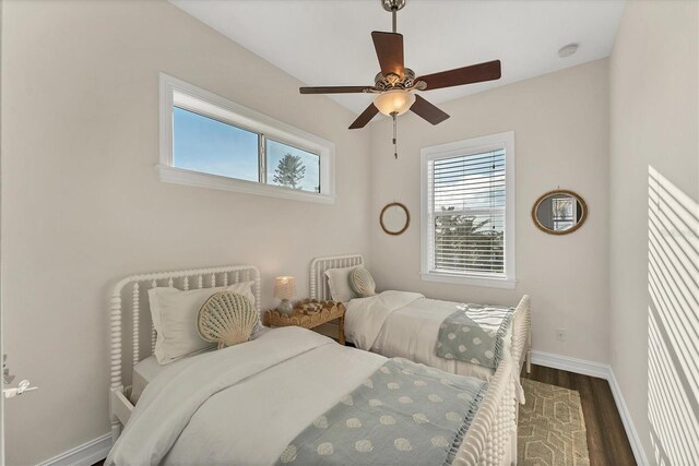 634 Key Royale Dr, Holmes Beach, FL 34217 - bedroom with baseboards, wood finished floors, and ceiling fan