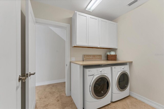 634 Key Royale Dr, Holmes Beach, FL 34217 - washroom featuring separate washer and dryer, cabinet space, and baseboards
